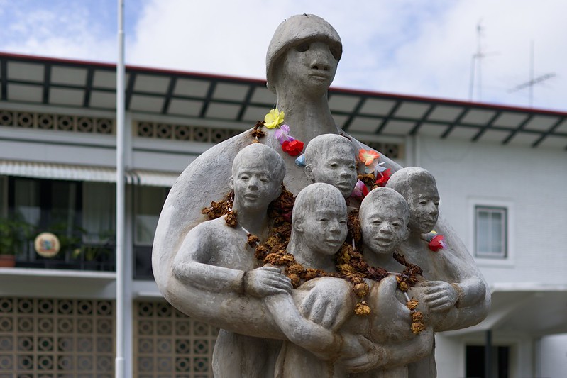 Op de foto zie je het standbeeld Mama Sranan In Suriname. Het beeld herinnert aan Keti Koti of emancipatiedag. Mama Sranan vertegenwoordigt moeder Suriname en geeft een weergave van de verschillende bevolkingsgroepen.